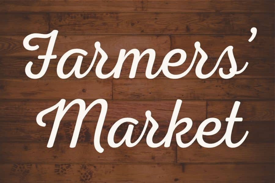 Farmers' Market text on a rustic wooden background